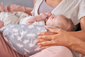 Theraline Stillkissen mit individuellem Bezug, modell auf einem Bett, ergonomisch geformt für Komfort beim Stillen.